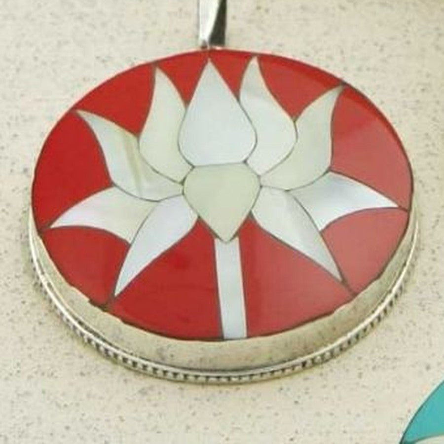 Close-up of the coral lotus pendant with its scalloped sterling silver bezel