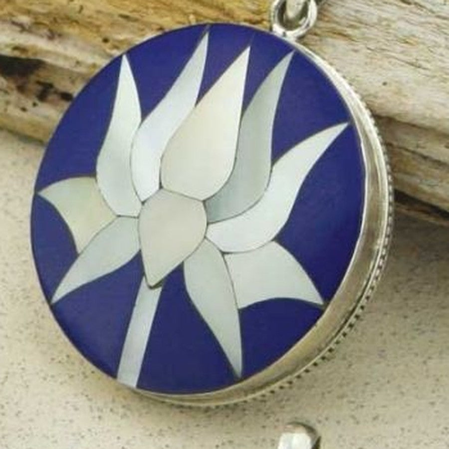 Close-up of the lapis lotus pendant: mother-of-pearl petals set into deep blue