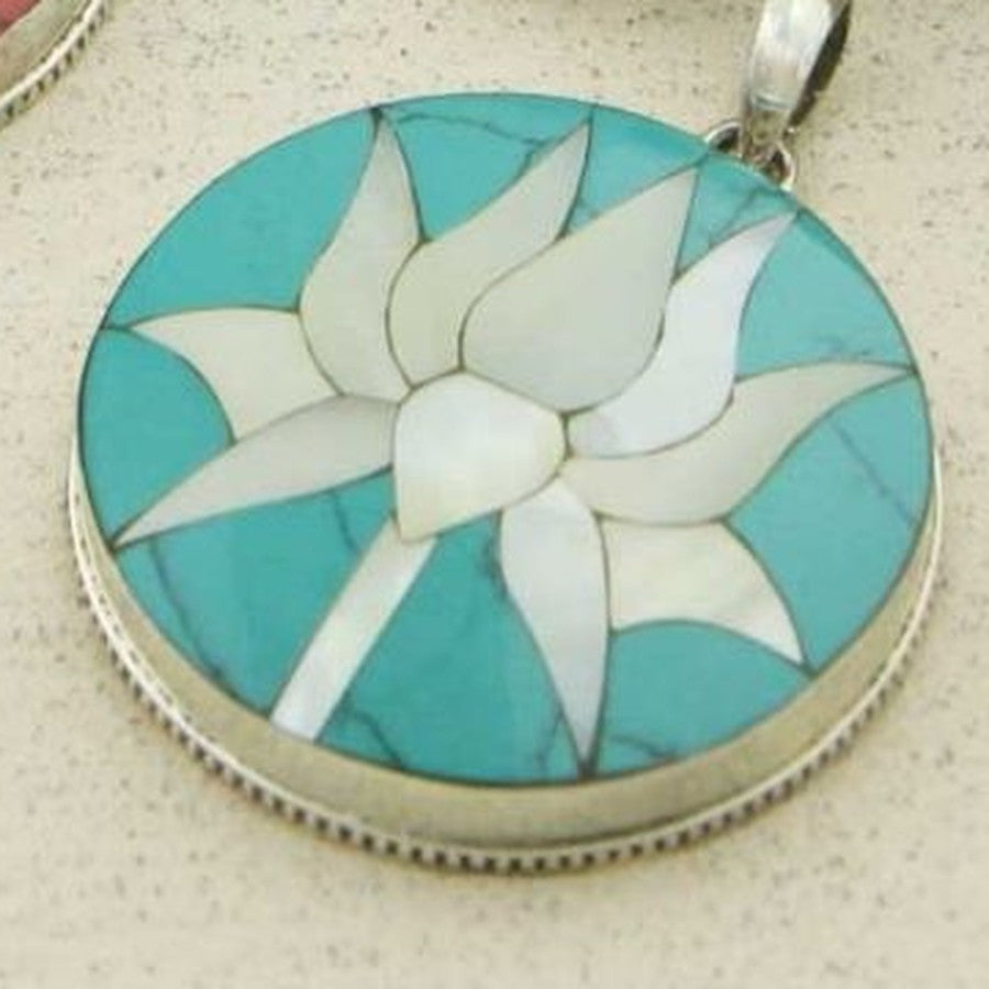 Close-up of the turquoise lotus pendant showing the stone's natural veining