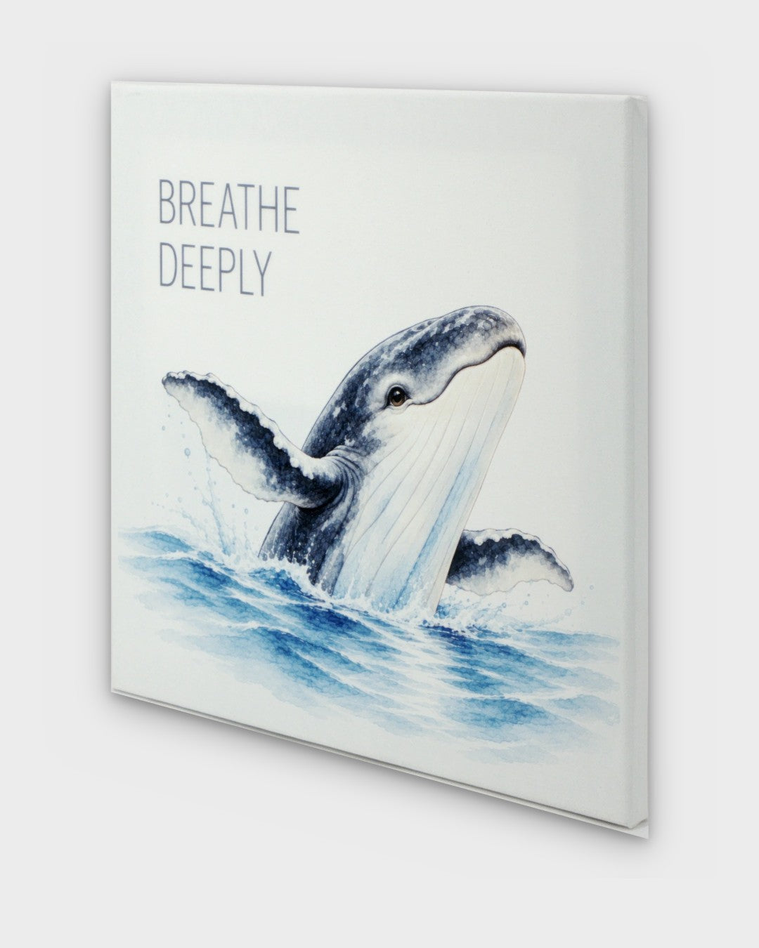 Breathe Deeply watercolor whale canvas wall art, angled side view showing canvas depth and wrapped edges with breaching whale illustration