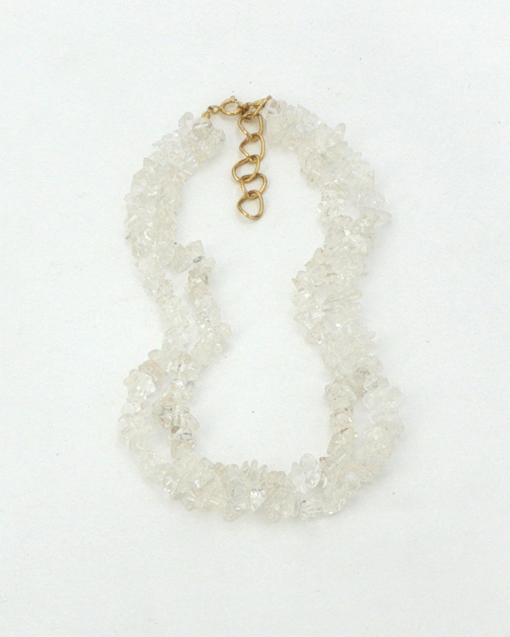 Clear quartz chip necklace, two strands laid flat on white with the gold tone clasp and extender at the top