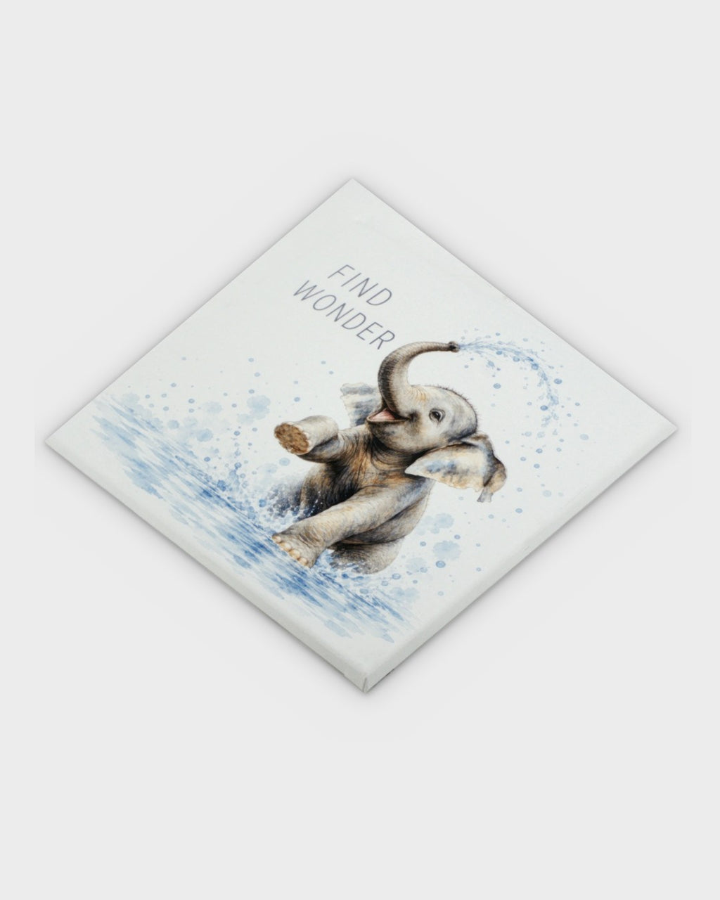 Find Wonder baby elephant canvas wall art photographed at a diagonal angle showing the wrapped canvas corners and thickness
