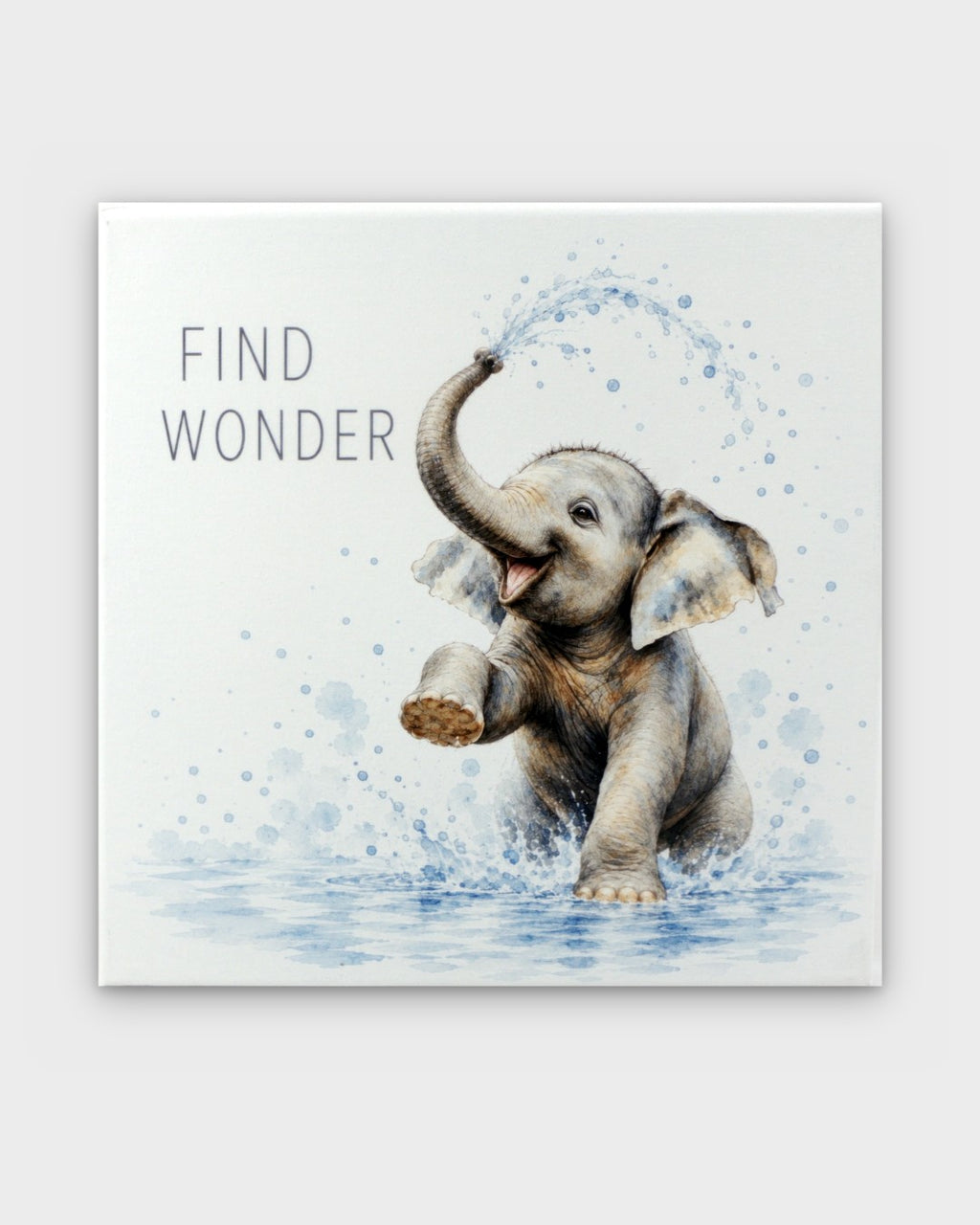 Find Wonder watercolor canvas wall art showing a baby elephant splashing water with trunk raised, front view