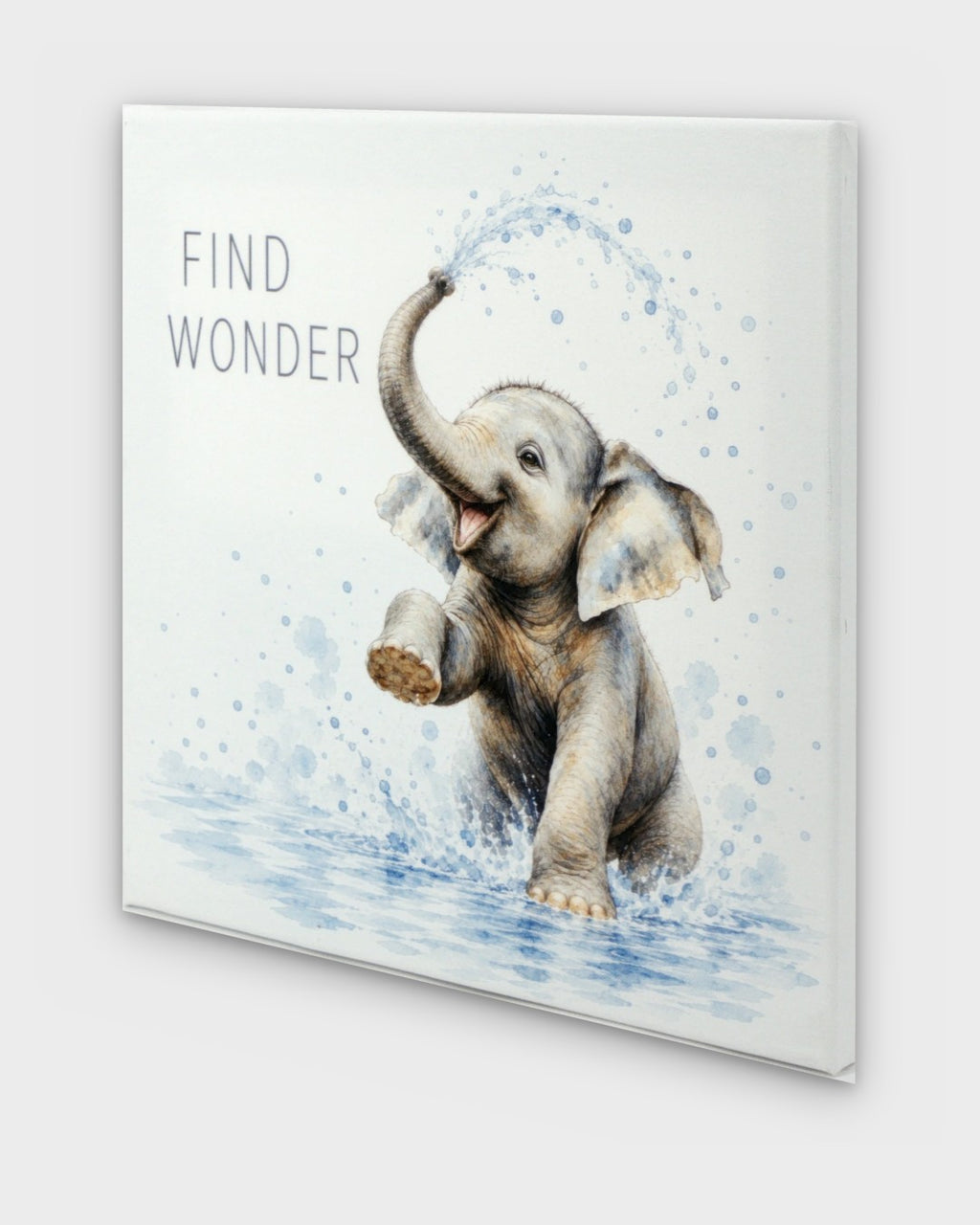 Find Wonder baby elephant watercolor canvas wall art at an angle, showing wrapped edge depth and side profile