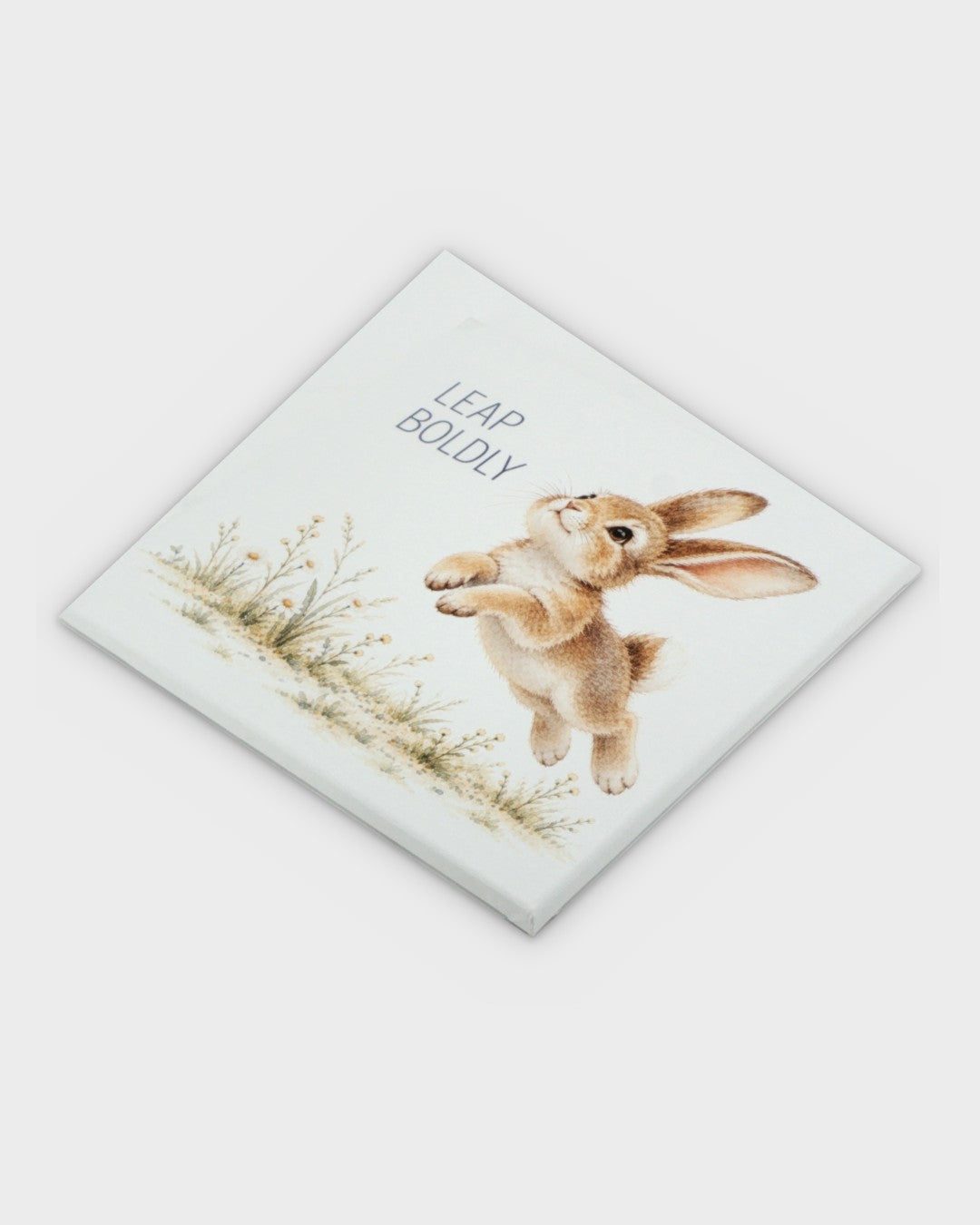 Leap Boldly watercolor bunny canvas wall art, overhead diagonal view showing canvas texture and print detail