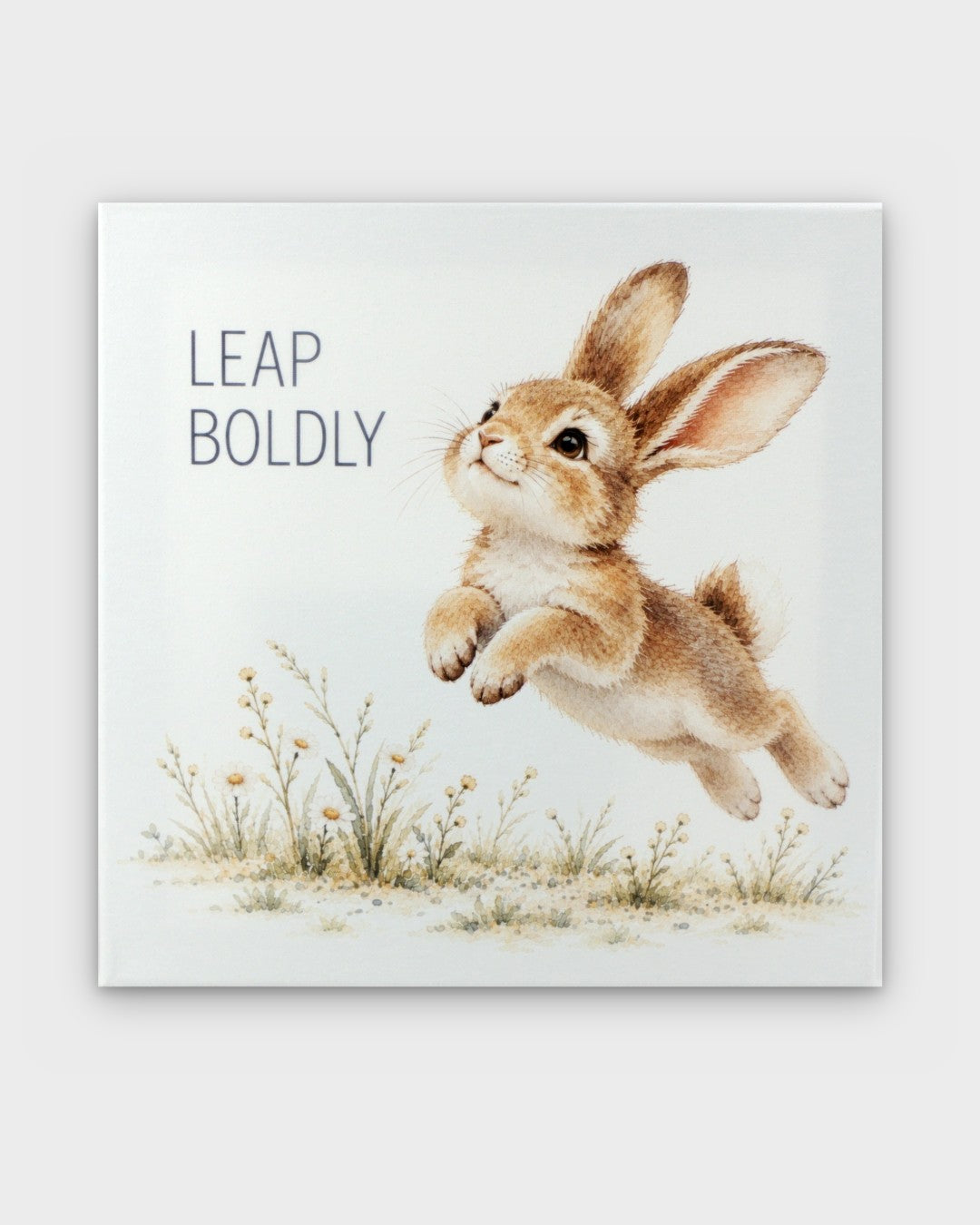 Leap Boldly watercolor bunny canvas wall art, front view showing leaping rabbit with wildflowers and text
