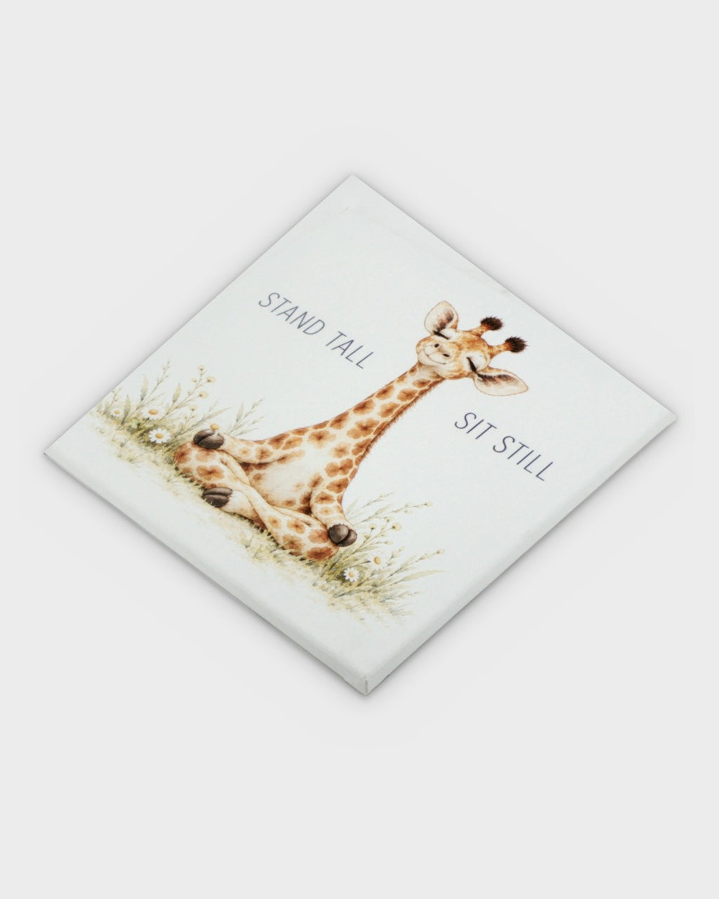 Meditating giraffe canvas wall art photographed at a diagonal angle showing the full printed surface and canvas wrap construction