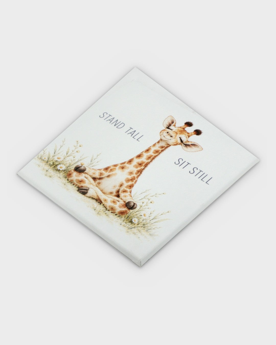 Meditating giraffe canvas wall art photographed at a diagonal angle showing the full printed surface and canvas wrap construction
