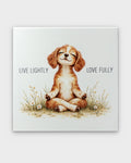 Meditating puppy canvas wall art, front view showing watercolor spaniel in lotus pose among wildflowers with Live Lightly Love Fully text
