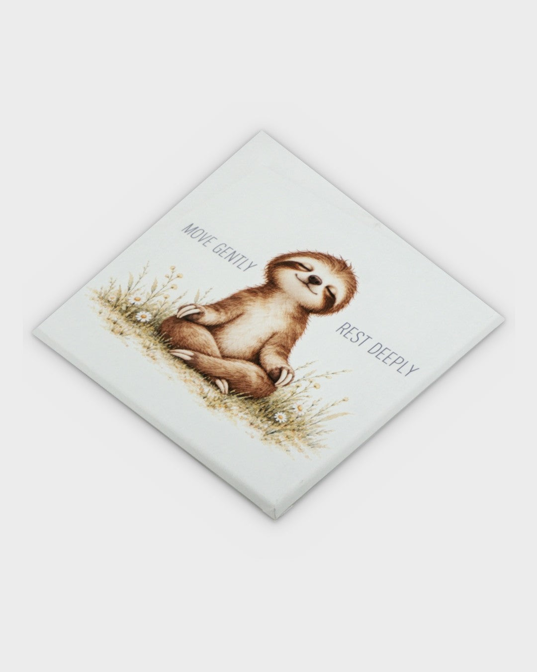 Meditating sloth canvas wall art tilted diagonally to show canvas thickness and printed surface texture