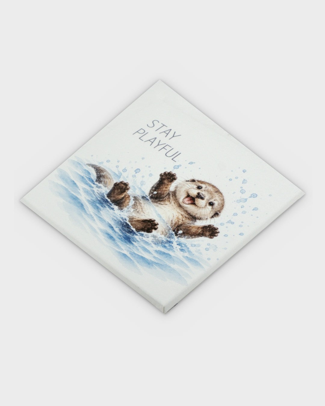 Stay Playful watercolor otter canvas wall art shown at a diagonal angle, displaying canvas thickness and corner detail