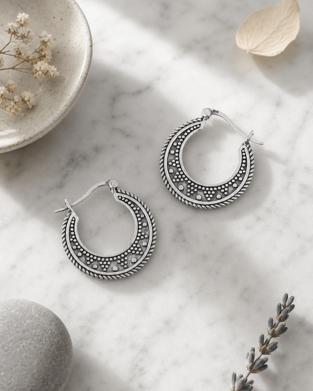 Textured Crescent Silver Hoop Earrings — earrings, editorial marble lifestyle photo