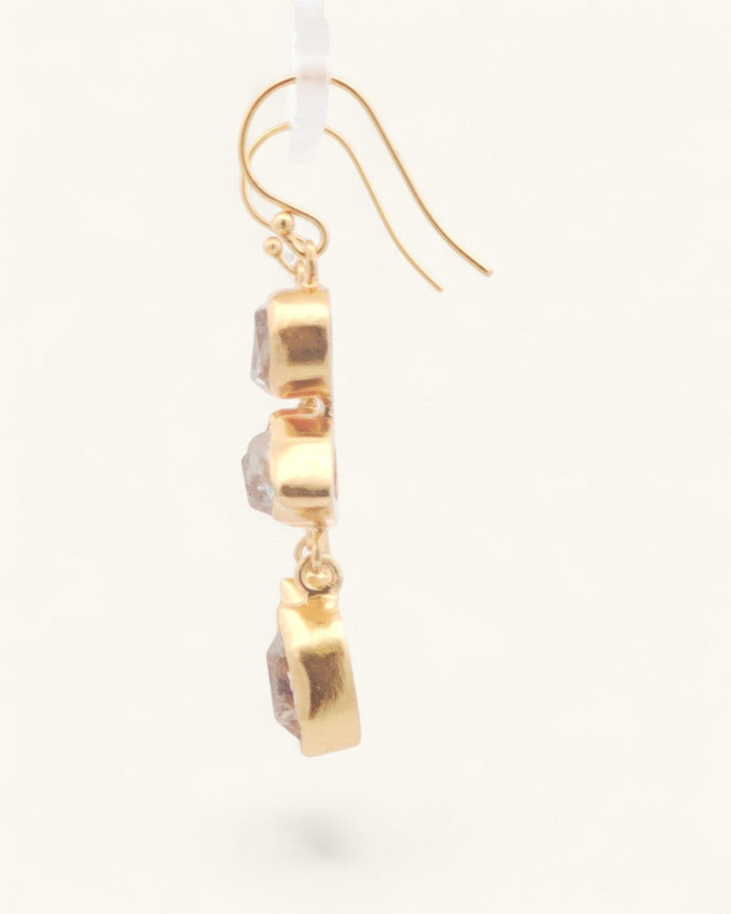 Single triple Herkimer quartz gold-plated drop earring in side profile, showing three stacked bezel-set raw crystal stones