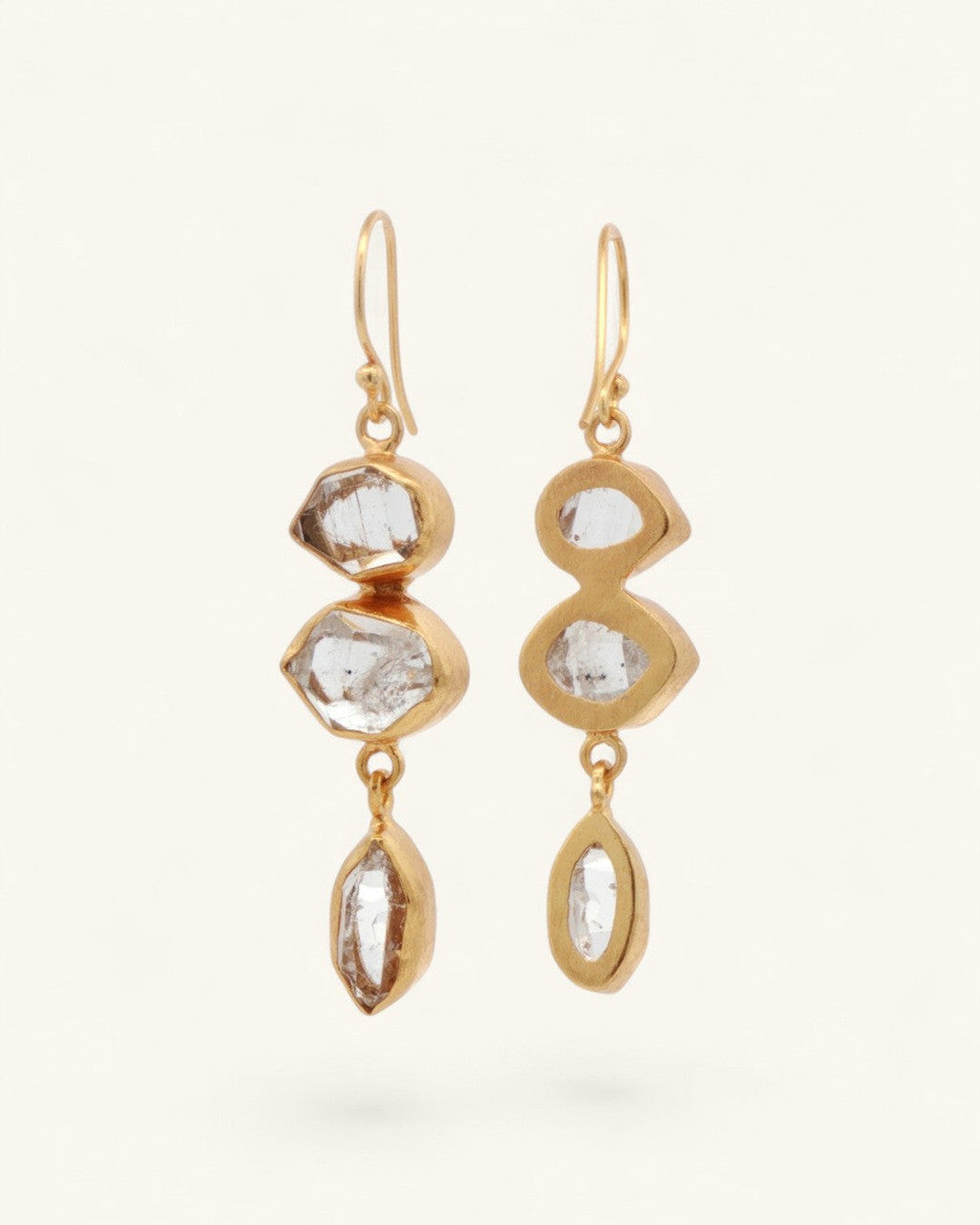 Triple Herkimer quartz gold-plated drop earrings at an angle, showing gold bezel back structure and varied stone settings
