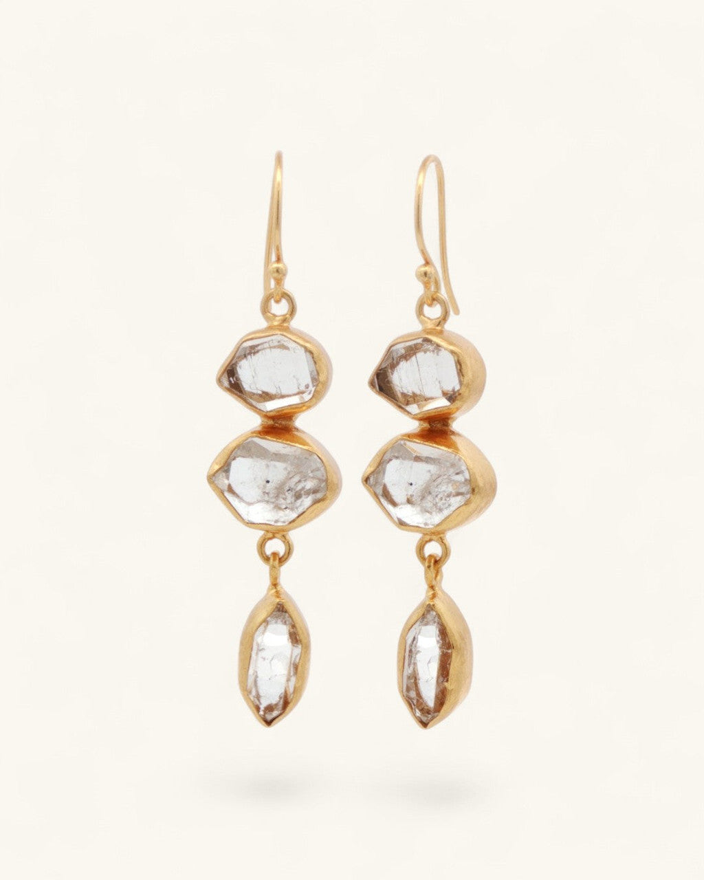 Triple Herkimer quartz gold-plated drop earrings, front detail view with crystal inclusions and facets visible in each stone