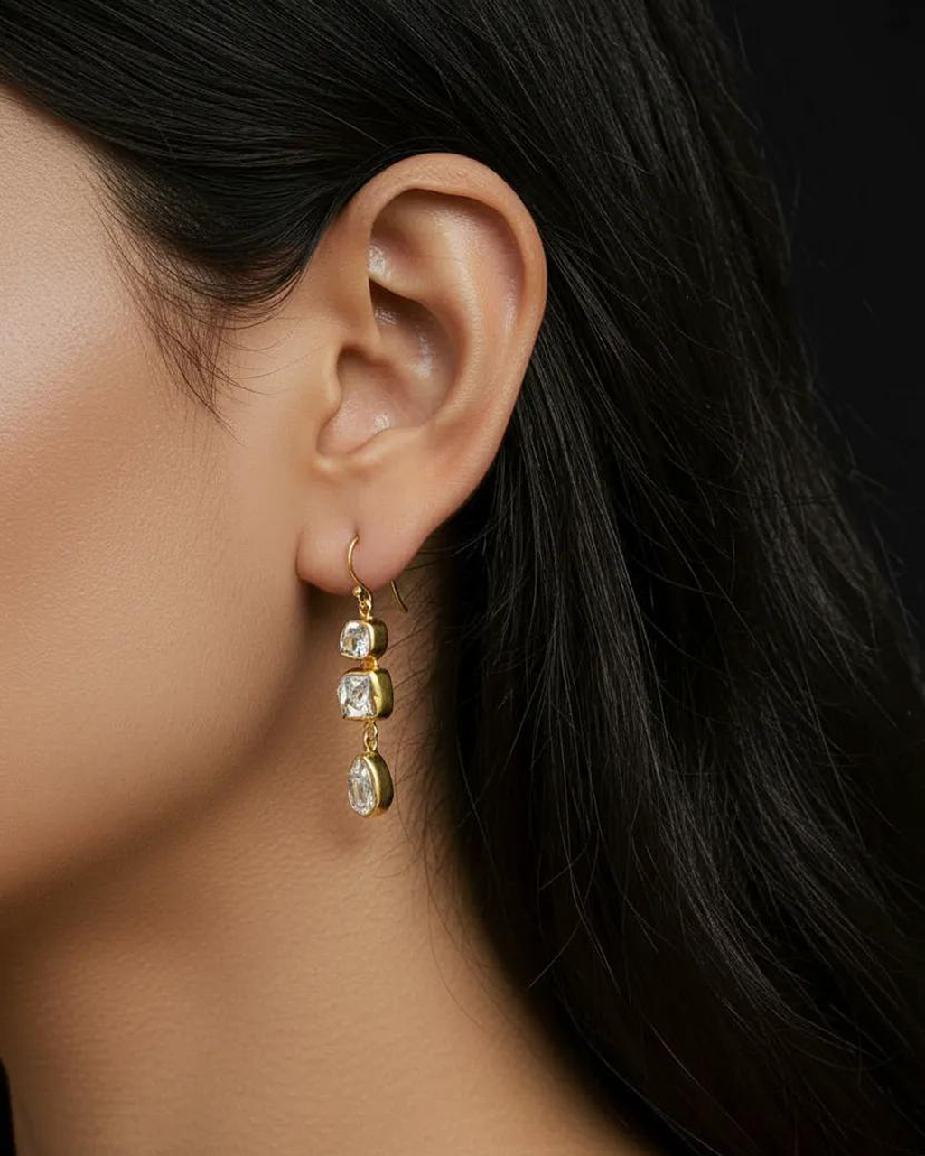 Triple Herkimer quartz gold-plated drop earring worn on model's ear, showing scale and three stacked crystal stones