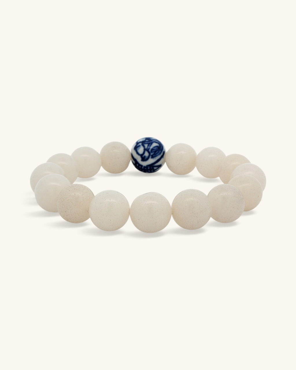 White jade bead bracelet standing upright, front view with the blue and white porcelain bead centered