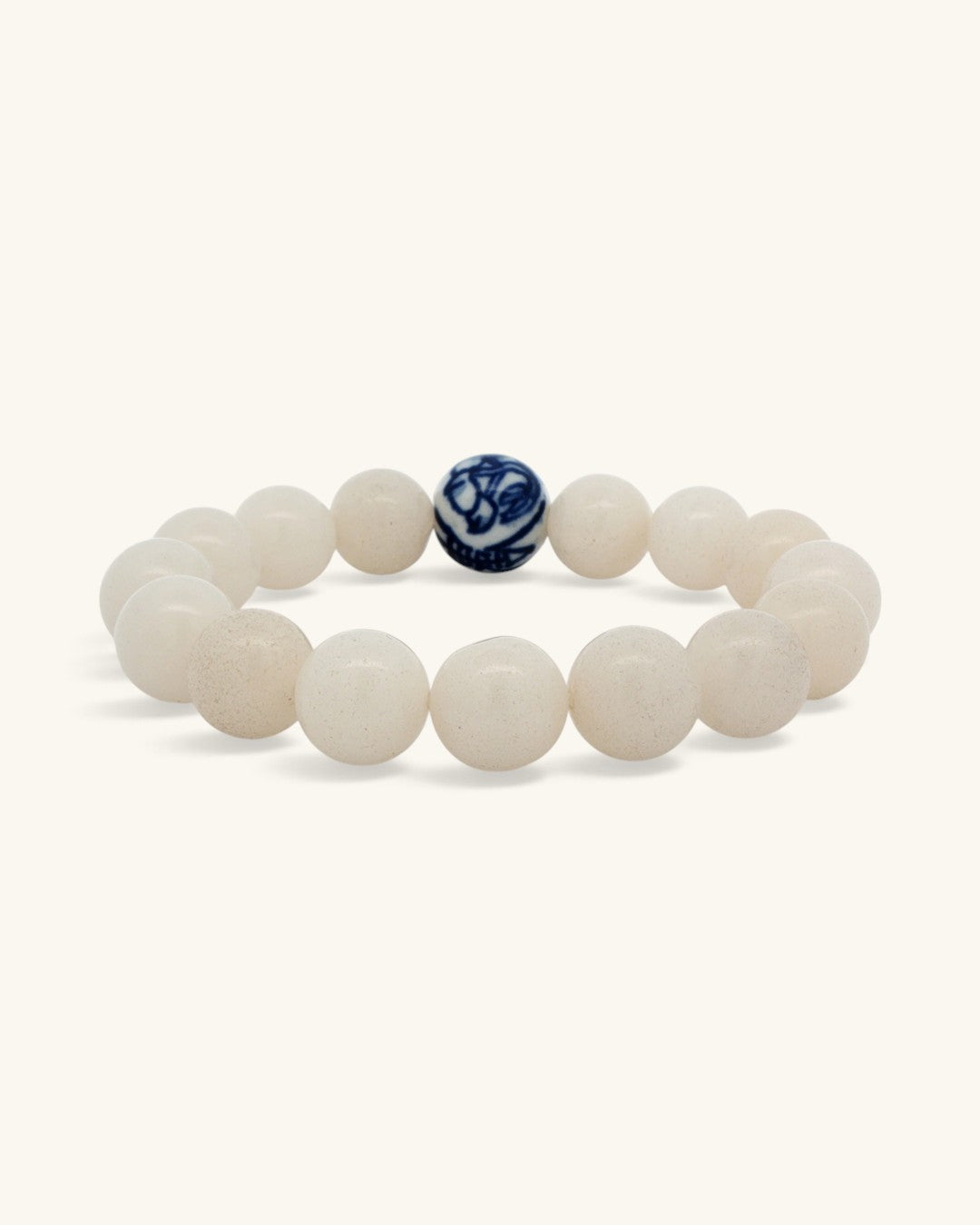 White jade bead bracelet standing upright, front view with the blue and white porcelain bead centered
